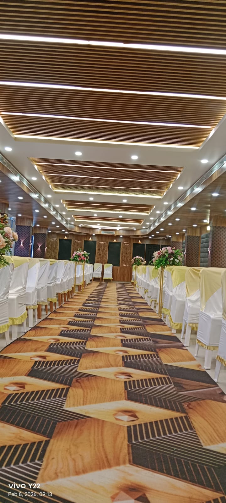 Ceremony aisle layout with floral accents inside the hall