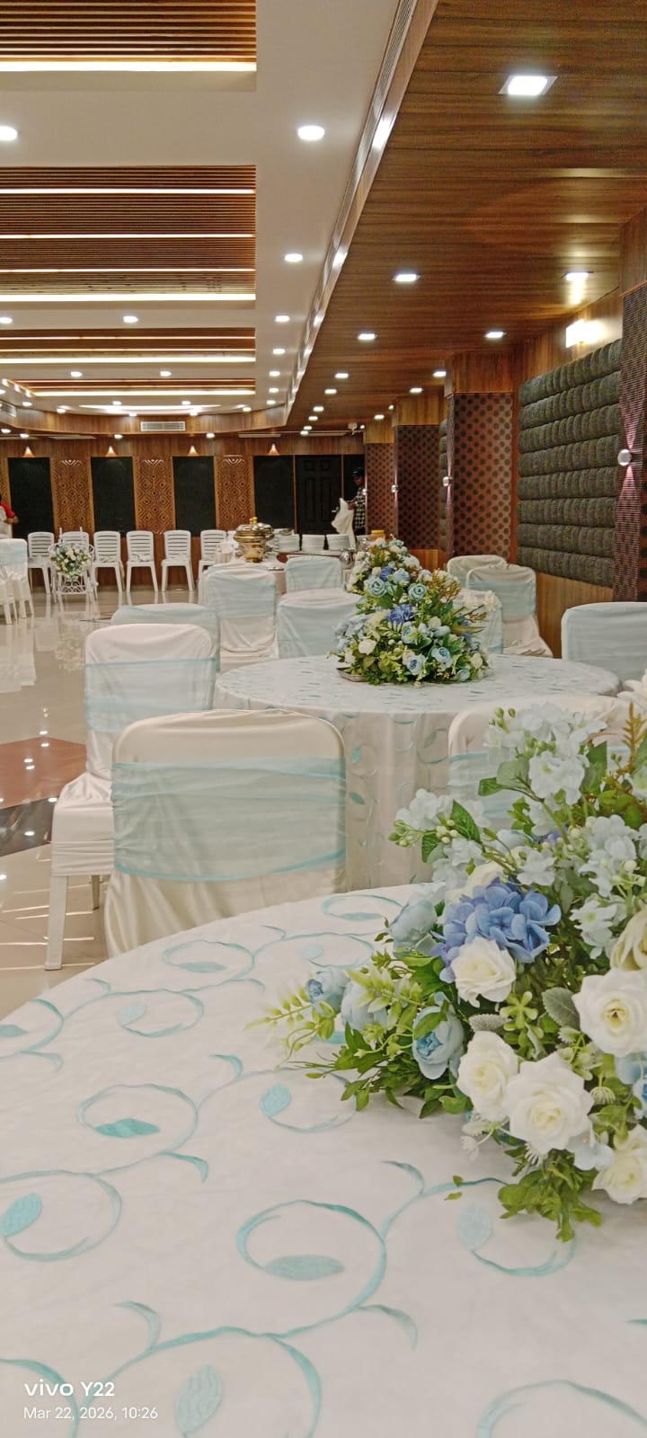 Reception dining tables styled with floral centerpieces