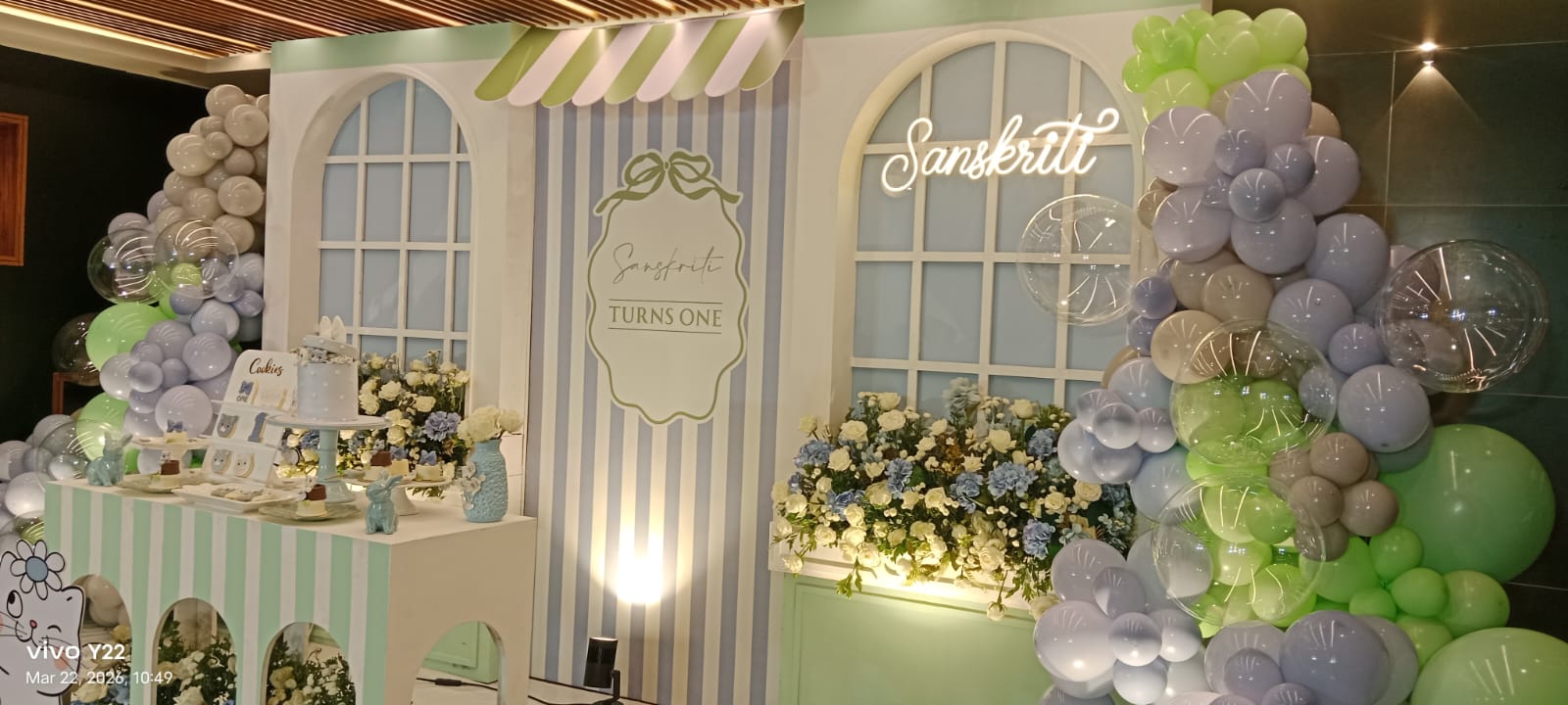 Close-up view of a pastel themed event backdrop and dessert table